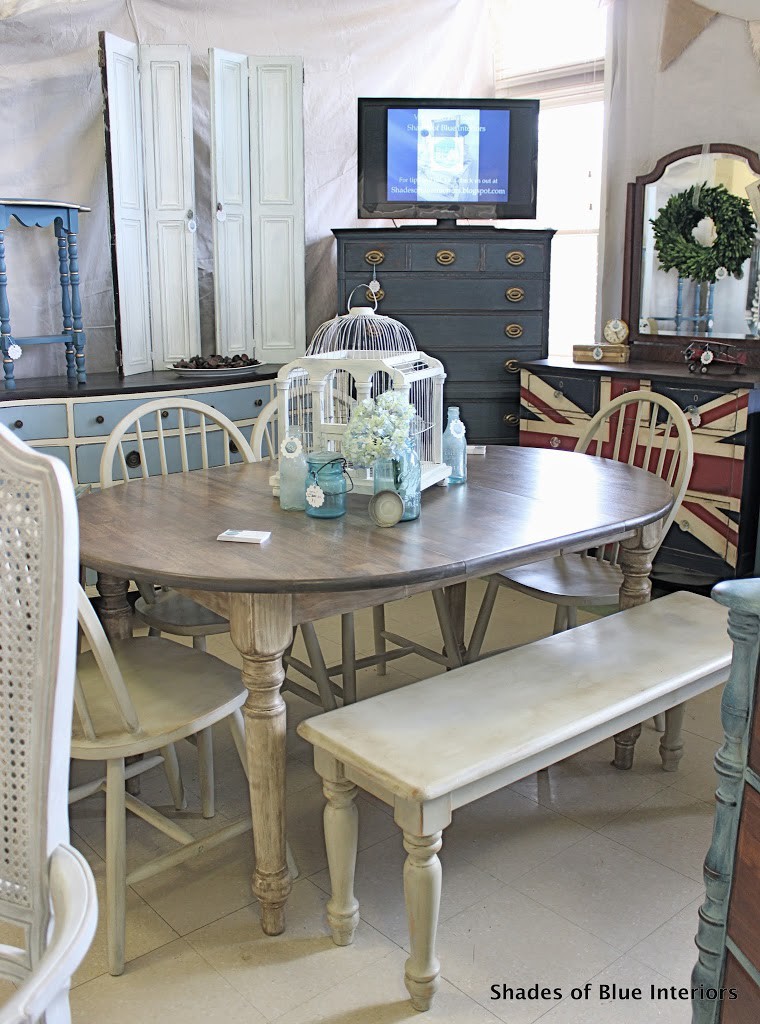 Creme and weathered gray dining set with birdcage and bottles on top in Shades of Blue Interiors booth