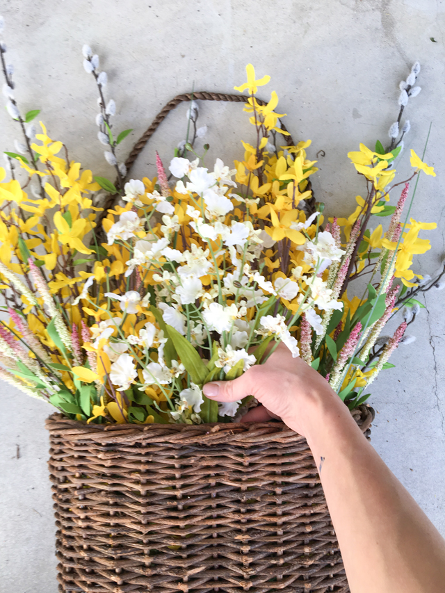 Adding-white-flowers to spring hanging basket
