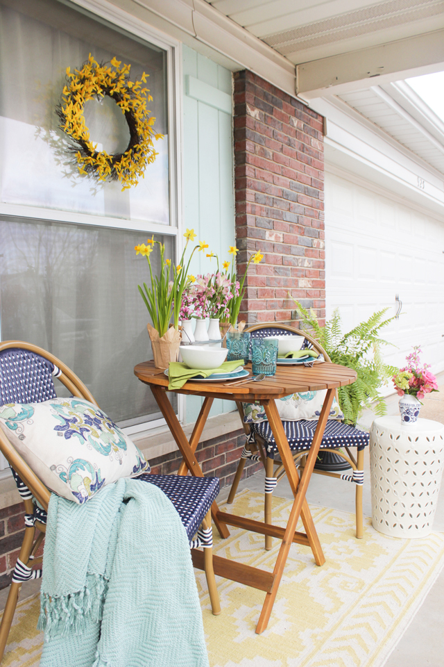 Front Porch Seating area decorated for spring with navy, aqua and pops of yellow