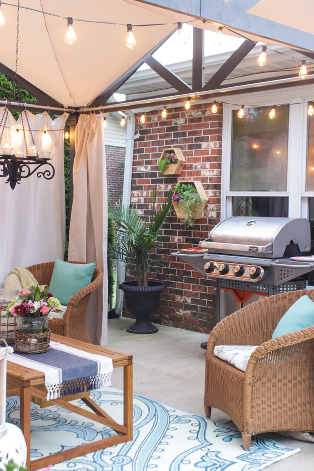 Stok Grill by pergola on summer patio with hex planters