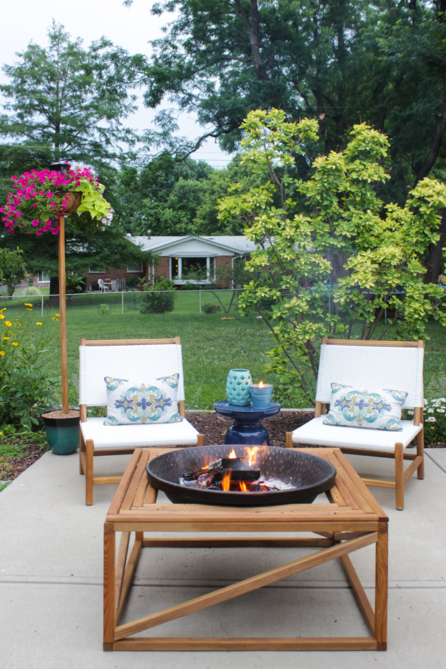 Outdoor fire pit with seating area and solar light pole