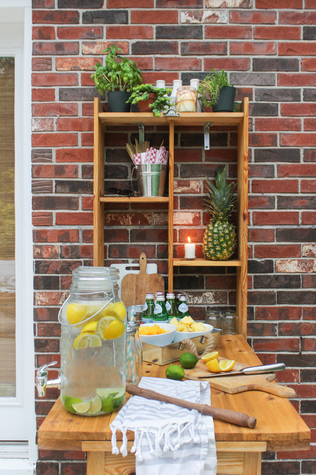 Outdoor murphy bar set up with fruit kebobs and lemon-lime water