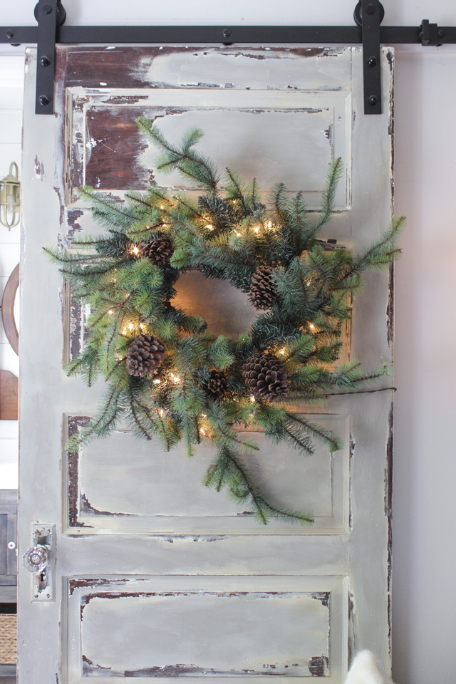 Christmas wreath on a barn door with chippy paint