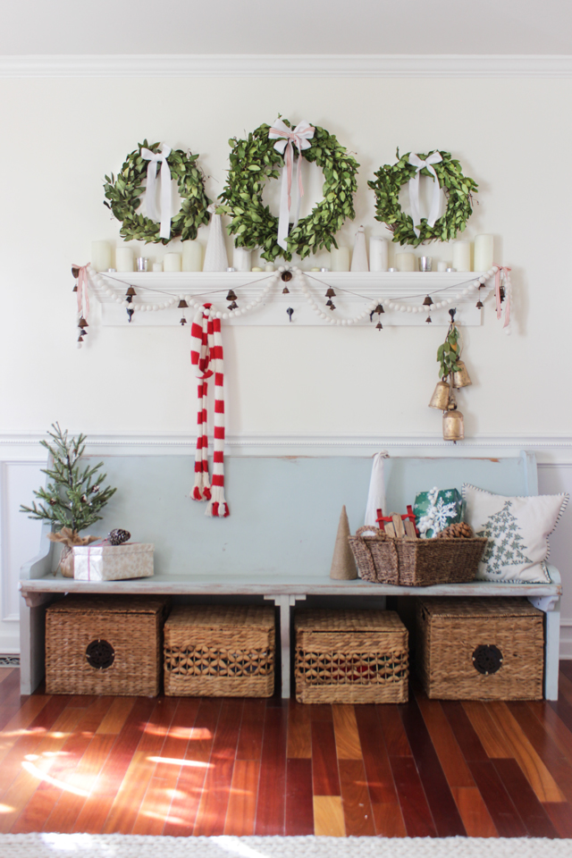 Christmas entry bench with three bay leaf wreaths above