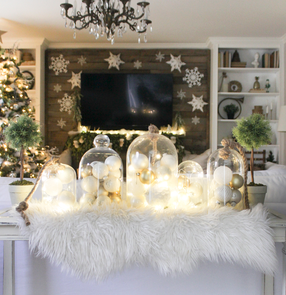 Glass cloches with lights and ornaments