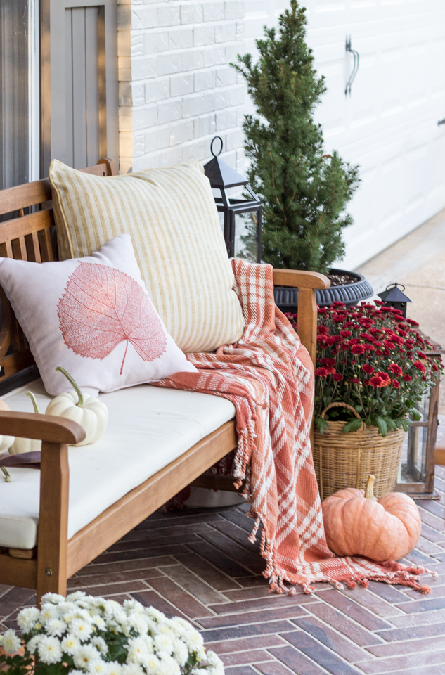 Cozy bench on a fall front porch