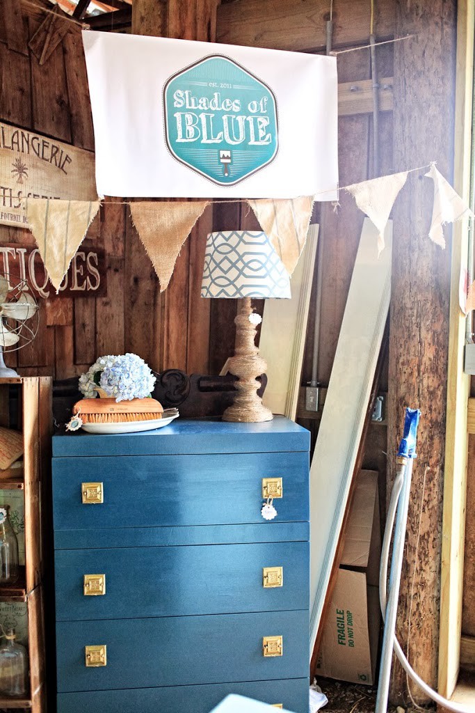 Blue mid-century highboy with jute lamp on top and Shades of Blue Interiors sign