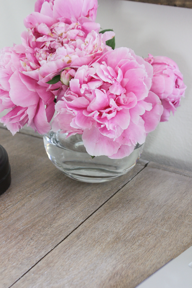 Peonies on top of a white-washed weathered oak finish rustic desk 