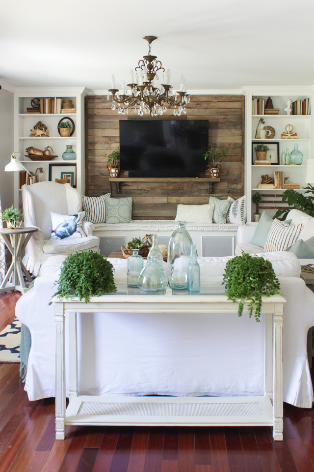 Rustic coastal living room for summer with white, aqua, and fresh plants