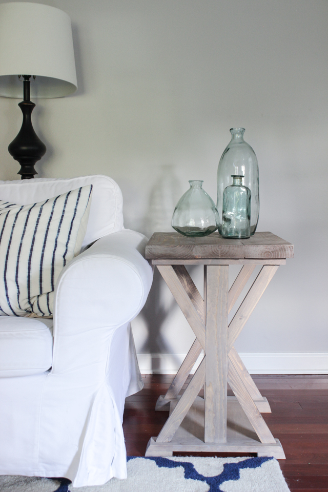 Farmhouse style X end table with light gray stained finish.