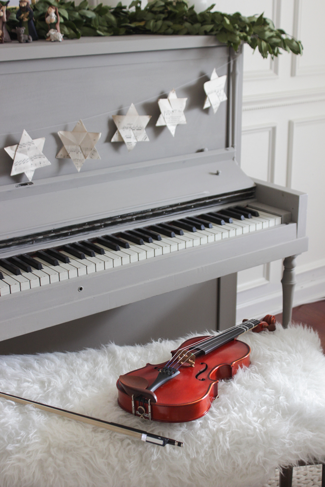 Gray piano, star garland, and violin
